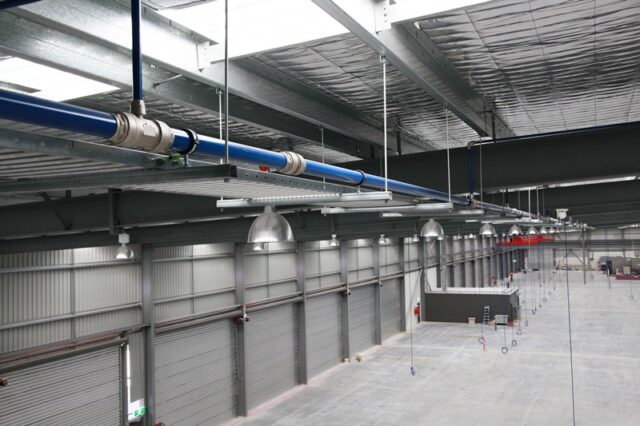 Aluminium piping system installed in industrial warehouse for robust piping solutions.