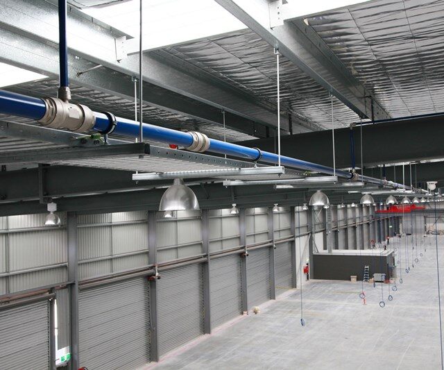 Aluminium piping system installed in industrial warehouse for robust piping solutions.