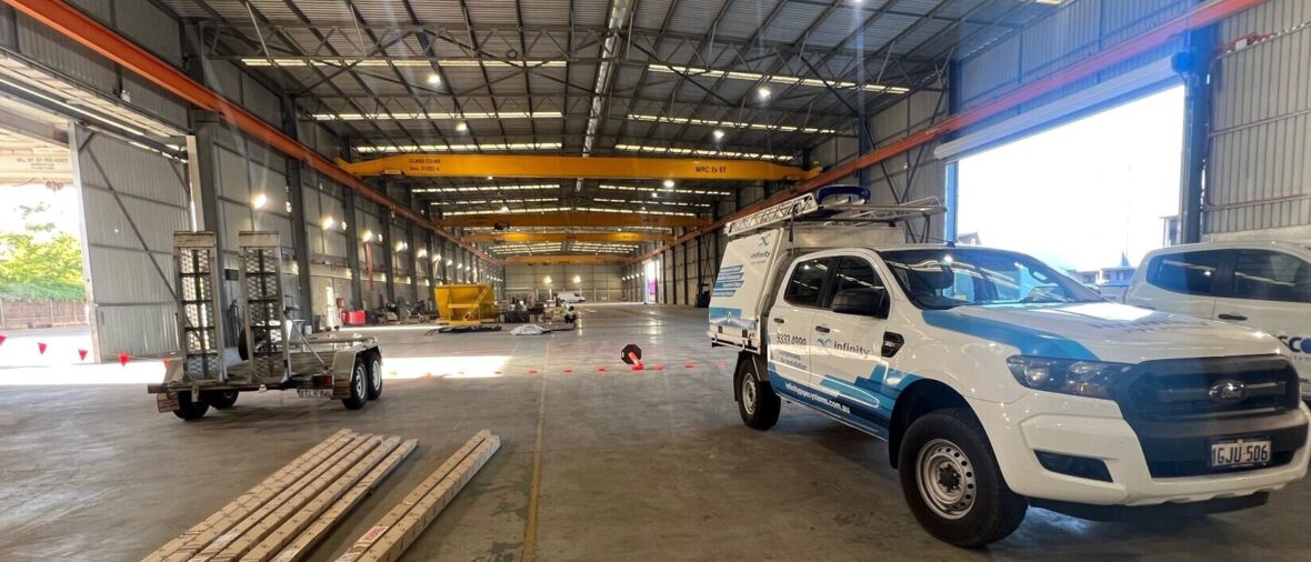 Infinity installer ute parked in a warehouse in the process of being fitted out for use. Compressed air line pipework being installed