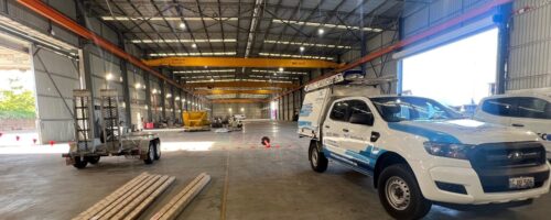 Infinity installer ute parked in a warehouse in the process of being fitted out for use. Compressed air line pipework being installed