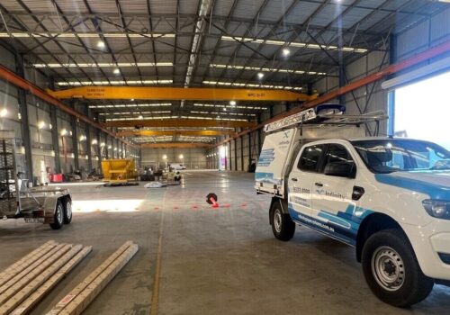 Infinity installer ute parked in a warehouse in the process of being fitted out for use. Compressed air line pipework being installed