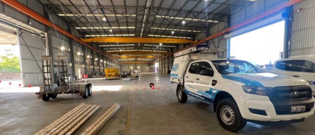 Infinity installer ute parked in a warehouse in the process of being fitted out for use. Compressed air line pipework being installed